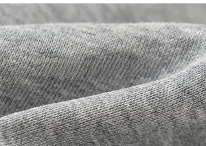 Close-up macro view of the grey heather knit fabric texture on kids' athletic pants