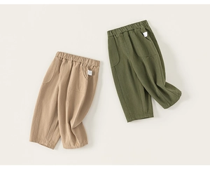 Detail of khaki and army green kids cotton trousers with elastic waist and side pockets