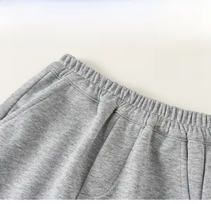 Close-up of the elastic waistband on gray knit pants showing soft cotton fabric and seams