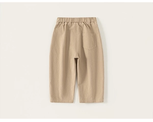 Detail view of the back of khaki cotton kids trousers featuring an elastic waist and pocket