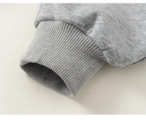 Close-up of the ribbed cuff design and soft knit texture of light grey joggers