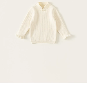 Detail of girls' cream knit sweater showing mandarin collar with Chinese knot buttons