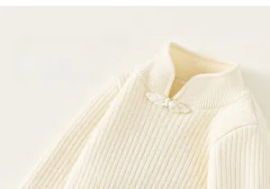 Detail of cream knit sweater showing vintage mandarin collar and traditional knot button