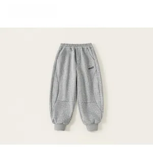 Close-up of boys gray jogger pants featuring ribbed cuffs and reinforced knee stitching