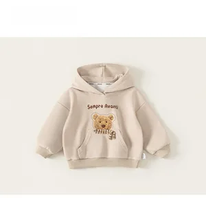 Détail d'un sweat à capuche beige enfant avec broderie ours et poche kangourou