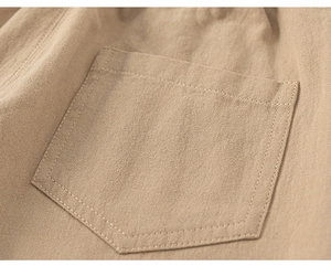 Detailed macro view of khaki cotton twill fabric texture and pocket stitching on trousers