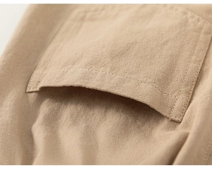 Detailed close-up of natural cotton fabric texture and precise pocket stitching on pants