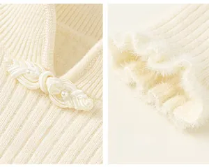 Close-up of girls knit sweater with pearl toggle buttons and elegant ruffled edges