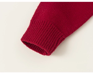 Detailed close-up of the red ribbed knit cuff on a soft children's cardigan sweater