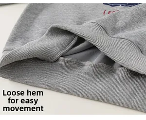 Close-up of the ribbed elastic hem on a gray knitted hoodie for kids with soft fabric