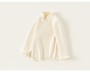 Close-up of knit sweater with mandarin collar, Chinese frog buttons and faux fur cuffs