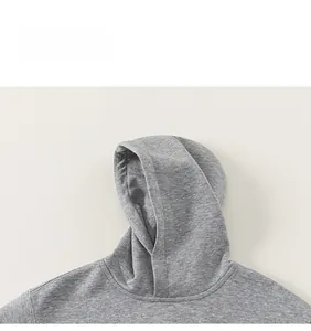 Detail of grey hooded sweatshirt showing high-quality cotton knit fabric and minimalist collar