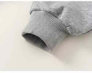 Detail of ribbed cuffs on grey cotton jogger pants showing high-quality knitted texture