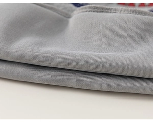 Macro shot of grey knitted fabric texture and fine stitching on children's hoodie