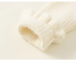 Detailed close-up of ribbed knit sleeve with soft faux fur trim in off-white color