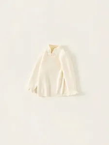 Girls cream knit sweater with stand collar, frog buttons, and fuzzy cuffs in flat lay