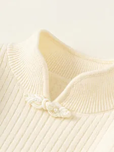 Cream white girls knit sweater with ribbed stand collar and pearl button detail