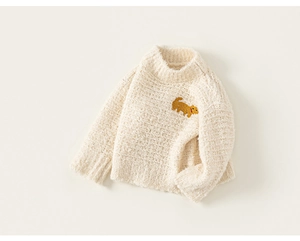Detail of children's cream knit sweater featuring a brown puppy embroidery and thick texture