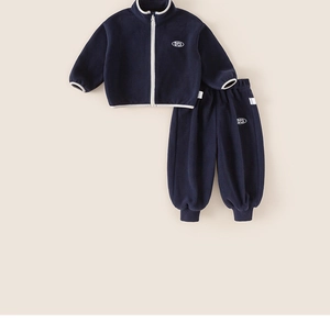 Flat lay of navy blue fleece tracksuit set with white zipper and logo embroidery