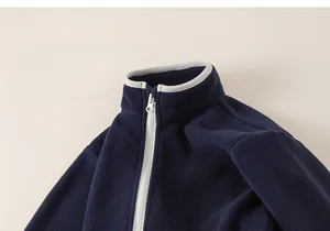 Close-up of navy blue polar fleece jacket with standing collar and logo embroidery