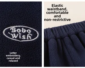 Detail of navy fleece pants featuring elastic waistband and Bobo Wish letter embroidery