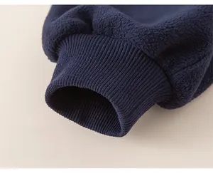 Detailed macro view of navy blue polar fleece fabric with elastic ribbed cuffs