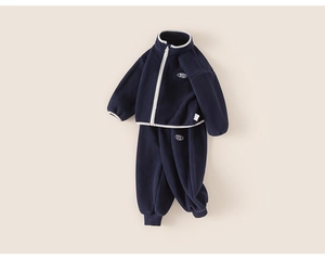 Detailed view of dark blue fleece tracksuit for kids with white zipper and embroidery