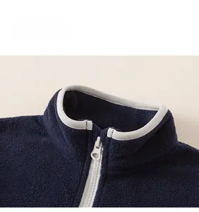 Detail of navy fleece jacket collar and zipper with grey piping for autumn winter
