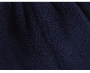 Close-up of soft navy blue fleece fabric showing thick texture and warm material detail