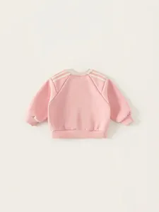 Pink toddler sweatshirt with triple shoulder stripes and ribbed cuffs on plain background