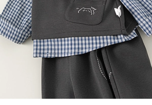 Detail of toddler 3-piece set with cartoon cat embroidery on dark grey vest and plaid shirt