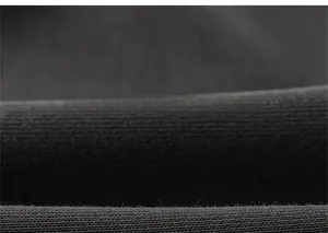 Macro shot of black knit fabric texture showing high-elasticity cotton blend weaving details