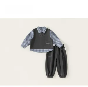 Detail view of boys' three-piece set with cat embroidery and blue checkered shirt