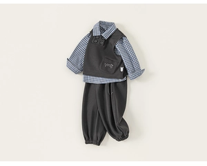 Detail of boys' 3-piece British style suit with embroidery on grey vest and plaid shirt