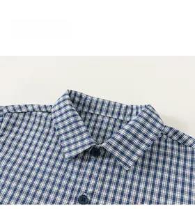 Detailed close-up of blue and white checkered cotton shirt collar with red embroidery
