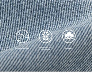 Macro detail of soft light blue denim fabric showing breathable twill texture and skin-friendly quality
