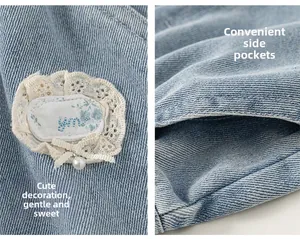 Detail of light blue denim with lace embroidery, ribbon bow, and pearl charm pocket