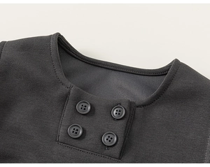 Close-up of boys knit sweater neckline with decorative square patch and four resin buttons