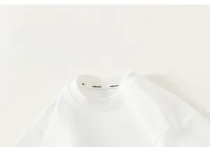 Close-up of white cotton t-shirt neckline with high-quality interior branded ribbon