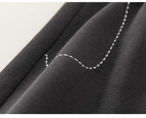 Close-up of high-density dark grey knitted fabric showing soft texture and fine stitching
