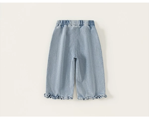 Detailed view of light blue kids jeans featuring ruffled hem edges and elastic waistband