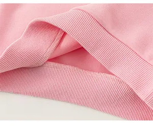 Close-up of pink ribbed knit hem and reinforced stitching on children's sweatshirt
