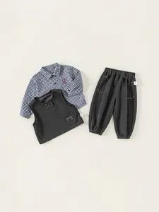 Three-piece boys casual outfit with blue plaid shirt, grey vest and jogger pants