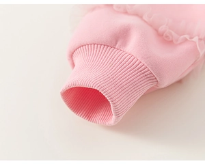 Detailed close-up of pink cotton sweatshirt ribbed cuffs with sweet lace trim detailing