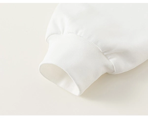 Detailed close-up of the white ribbed cuffs on this soft cotton long sleeve girl's shirt