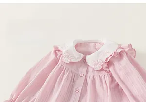 Detail of pink striped baby doll shirt featuring white Peter Pan collar and rabbit embroidery