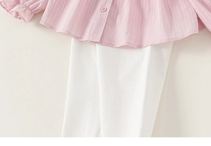 Detail of pink striped long-sleeve blouse with ruffle cuffs and white slim pants set
