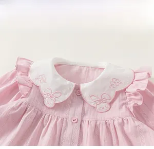 Detailed view of pink toddler shirt with white Peter Pan collar and rabbit embroidery