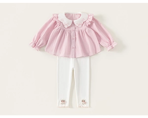 Detail of pink toddler blouse with rabbit embroidery and white pants with lace trim
