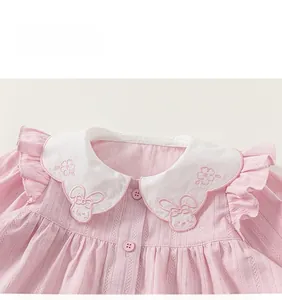 Close-up of pink doll shirt with white Peter Pan collar and cute rabbit embroidery